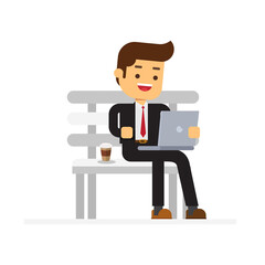 businessman working on laptop sitting on a park