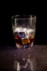 Cold americano decoration with stainless steel cubes ice  on a black table.