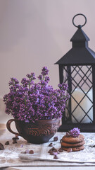 Decorative composition with a Bouquet of lilacs. Clay cup of tea and chocolate cake. A bouquet of lilacs in a vase. Spring floral background with lilacs in the interior. 
