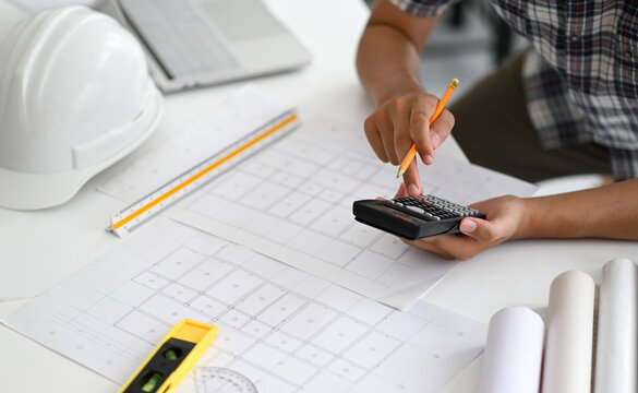 Architects are using a calculator to estimate the cost of house plans.