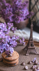 Decorative composition with a Bouquet of lilacs. Clay cup of tea and chocolate cake. A bouquet of lilacs in a vase. Spring floral background with lilacs in the interior. 