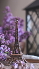 Decorative composition with a Bouquet of lilacs. Clay cup of tea and chocolate cake. A bouquet of lilacs in a vase. Spring floral background with lilacs in the interior. 