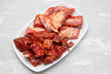 marinated raw meat and ribs on white dish