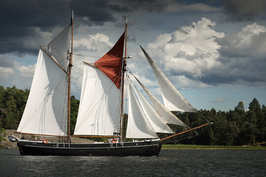An elegant two-masted gaff schooner (training tall ship) sailing in M&auml;laren lake, Sweden. Travel, history, traditions, transportation, sailing, sport, cruise, regatta, teamwork. Panoramic view