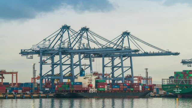 crane loading container box to container cargo freight ship in port shipping containers a logistics business and global trading. logistics, global business and transportation concept