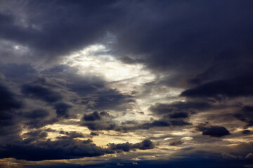 Sky obscured by dark clouds . Wispy storm clouds in the twilight