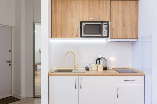 Interior photography, modern bedroom, with large stylish bed, modern design, whith small kitchen