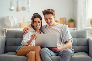 young couple is using laptop