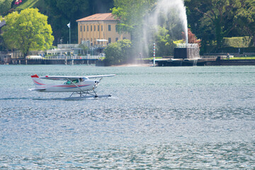 Obraz premium Take off of a seaplane over the waters of Lake Como, Como, Italy. This airplane take tourists for a tour of the entire lake. If you plan a travel in Como do not miss it.