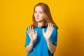 Keep away and leave me alone. Intense unhappy girl shows enough or stop gesture, expresses...