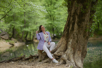 Beautiful young teen women in nature. Woman breathing fresh air in a green forest in summer 