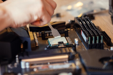 Application Of Thermal Paste On The computer Processor Chip For Cooling.