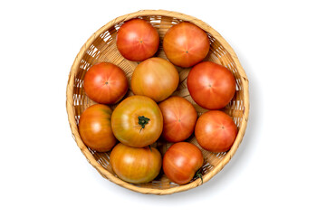 Tomatoes in a basket isolated on white background.