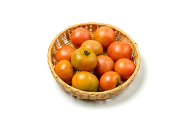 Tomatoes in a basket isolated on white background.