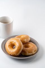 glazed donuts and coffee image. front view