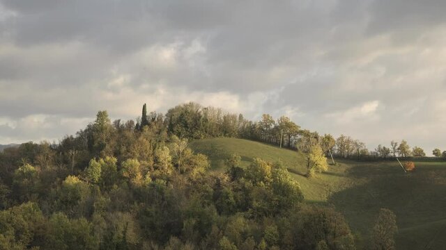 Time lapse of sunset in autumn above the hills with moving clouds, Emilia Romagna, Italy, Europe