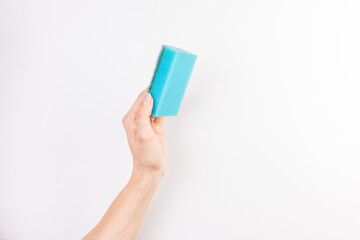 Sponge for washing dishes in female hand. Woman's hand gesture or sign isolated on white. A hand holds a sponge for washing and cleaning dishes