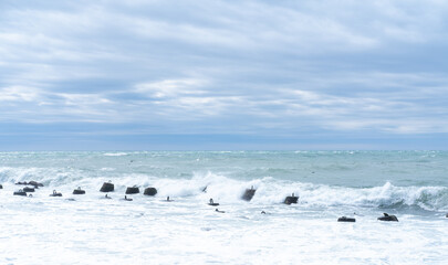 Waves breaking on Marine concrete breakwaters in shallow water. Traveling-wave protection, concrete breakwater