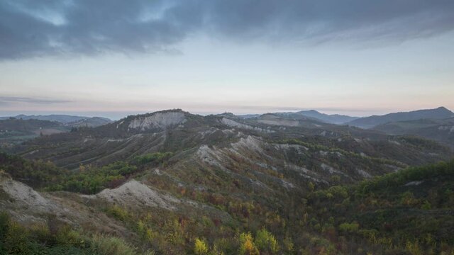 Time lapse of blue hour on badlands in autumn with moving clouds, Emilia Romagna, Italy, Europe