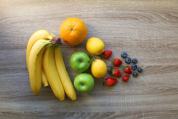 Various colorful fruit on wooden background. Flat lay.