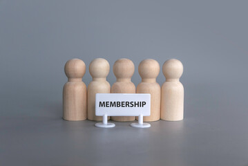 A wooden people standing in a row with a signboard of membership.