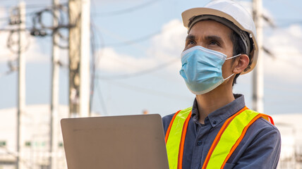 Engineer wear medical mask protect covid19 coronavirus and working outdoor computer technology