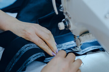 Closeup shot of a worker sewing in a textile factory
