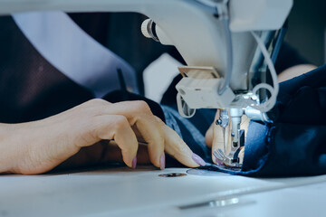 Closeup shot of a worker sewing in a textile factory