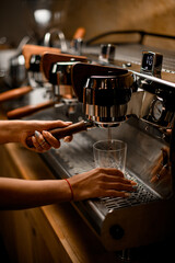 view of professional coffee machine with which barista prepares coffee