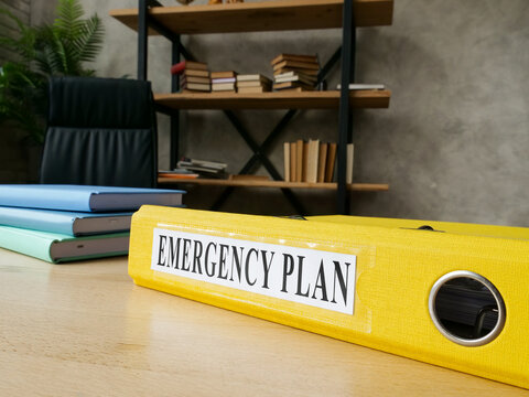 Emergency plan in the yellow folder on the desk.