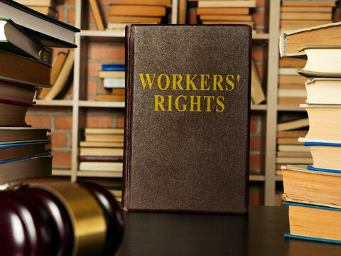 Employee and workers rights book with stack of documents.