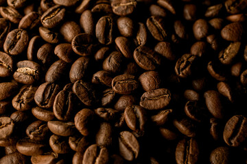 top view on composition of brown roasted coffee beans. Can be used as background.