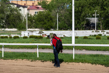 fans and players at the opening of the season at the racetrack on a sunny day 