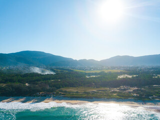 Fototapeta premium Paradise Beach Tropical Island Nature Sunny Sun Green Blue Sea Ocean Waves Water Sand Forest Florianopolis Santa Catarina Brazil 