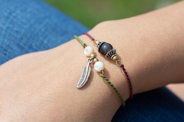 Obraz premium Female hand wearing popular gemstone mineral bead yoga bracelets