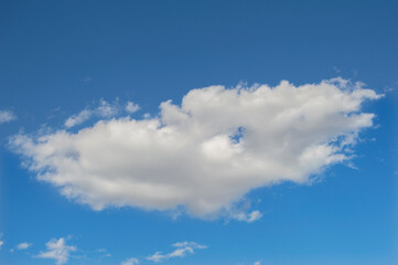 Naklejka na ściany i meble white cottony cloud over blue sky