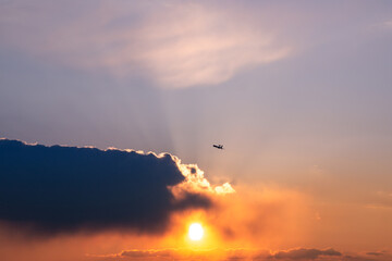 Awacs Plane at the Sunset with sun behind cloud, France