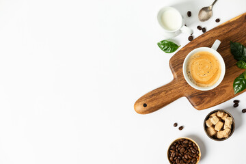 Cup of coffee on a wooden cutting board, flat lay, top view, copy space
