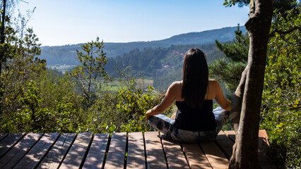 young woman meditation in the forest, doing sport outdoors panoramic view