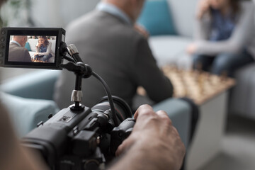 Videomaker shooting people playing chess