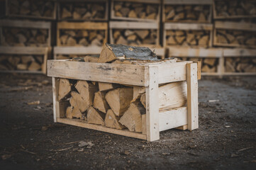 Set of cut firewood. Firewood in wooden crates. Piles of firewood.