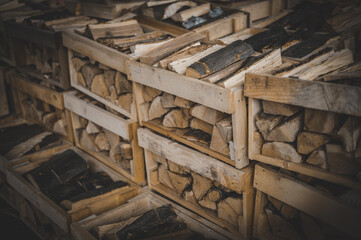 Set of cut firewood. Firewood in wooden crates. Piles of firewood.