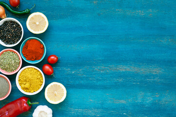 Colourful various vegatable and spices for cooking on blue background