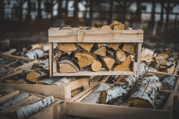 Set of cut firewood. Firewood in wooden crates. Piles of firewood.