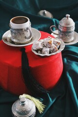 ethnic still life image of traditional ottoman empire fez, turkish coffee cup and plate with silver...