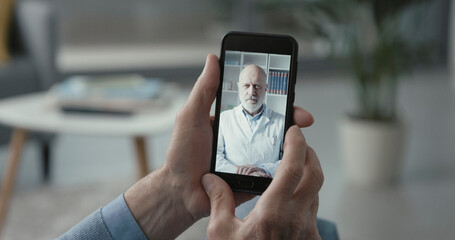 Elderly man video calling his doctor