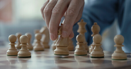 Senior man playing chess at home
