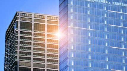 Glass facade of the buildings with a blue sky. Skyscrapers in the business city center.. Background of modern glass buildings. 