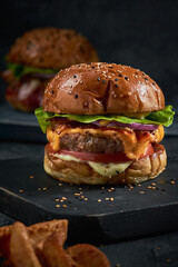 Vertical shot of a delicious burger on a blackboard