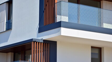 Condominium and apartment building with  symmetrical modern architecture. Detail in modern residential flat apartment building exterior. Fragment of new luxury house and home complex. 